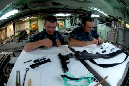 US Navy 110621-N-NK458-140 Sailors conduct maintenance on small arms in the torpedo room aboard the Los Angeles-class attack submarine USS Helena (