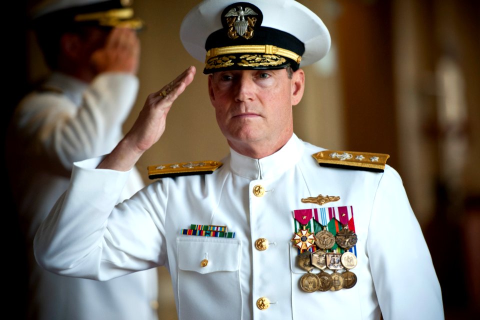 US Navy 110621-N-KK576-010 Rear Adm. Edward H. Deets III salutes as he is piped aboard for a retirement ceremony for Capt. Douglas W. Swanson