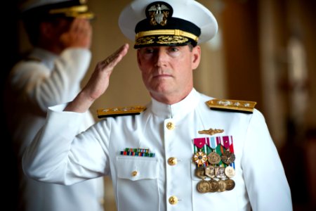 US Navy 110621-N-KK576-010 Rear Adm. Edward H. Deets III salutes as he is piped aboard for a retirement ceremony for Capt. Douglas W. Swanson
