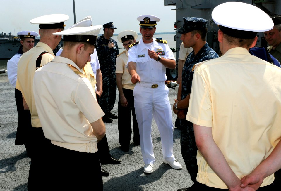 US Navy 110621-N-YY933-319 Lt. Cmdr. Brian Strananhan talks with sailors assigned to the Royal Navy of the United Kingdom destroyer Chabenenko (DD