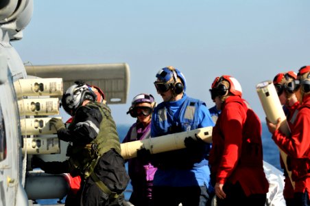 US Navy 110622-N-NL541-056 Sailors load sonar buoys onto an SH-60B Sea Hawk helicopter aboard USS Thach (FFG 43)