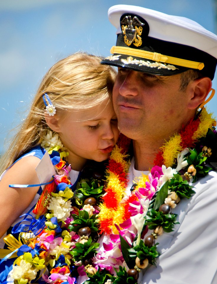 US Navy 110620-N-RI884-147 Cmdr. David Miller, commanding officer of the guided-missile frigate USS Rueben James (FFG 57), holds his daughter durin