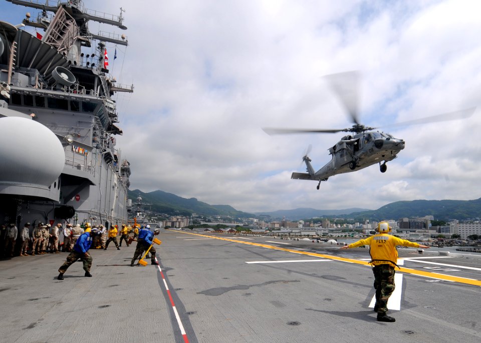 US Navy 110621-N-SO729-035 An MH-60S Sea Hawk helicopter prepares to land aboard USS Essex (LHD 2)