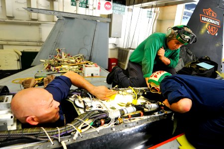 US Navy 110621-N-EE987-084 Civilian contractors Louis Villagran, left, and David Parrish work with Aviation Machinist's Mate 3rd Class Ernesto Mart