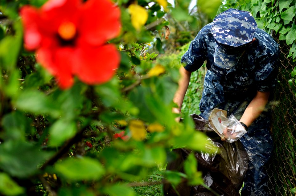US Navy 110622-N-WP746-135 Logistics Specialist Seaman Anthony Arebalo, assigned to Joint Base Pearl Harbor-Hickam, collects trash along Kamehameha