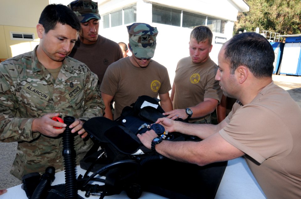 US Navy 110621-N-XD935-171 Lt. Javier Amor Alfaro explains the operation of Chilean diving gear to members of Mobile Diving and Salvage Unit (MDSU)