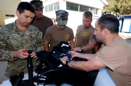 US Navy 110621-N-XD935-171 Lt. Javier Amor Alfaro explains the operation of Chilean diving gear to members of Mobile Diving and Salvage Unit (MDSU)