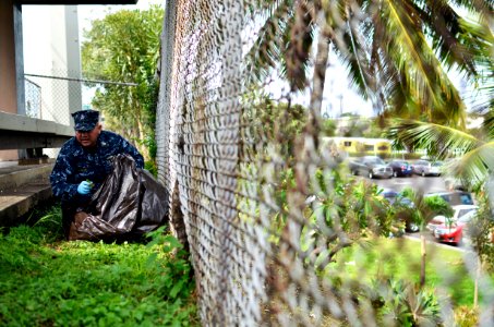 US Navy 110622-N-WP746-042 Chief Warrant Officer 3 Carlos Choto icks up rubbish along Kamehameha Highway, outside the Pearl Harbor Visitors Center