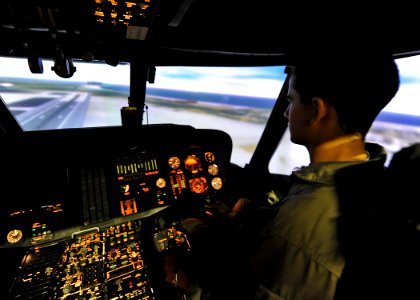 US Navy 110621-N-DX615-028 Midshipman 3rd Class Juan Vielma pilots a helicopter simulator while learning about the various job opportunities for pr