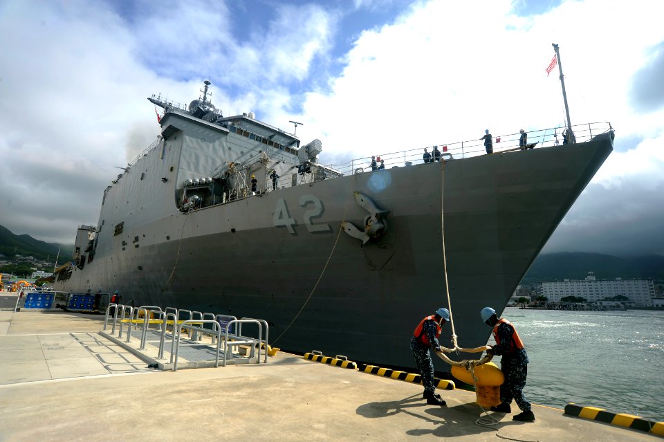 US Navy 110623-N-OX597-224 Sailors release a mooring line as the amphibious dock landing ship USS Germantown (LSD 42) departs U.S. Fleet Activitie