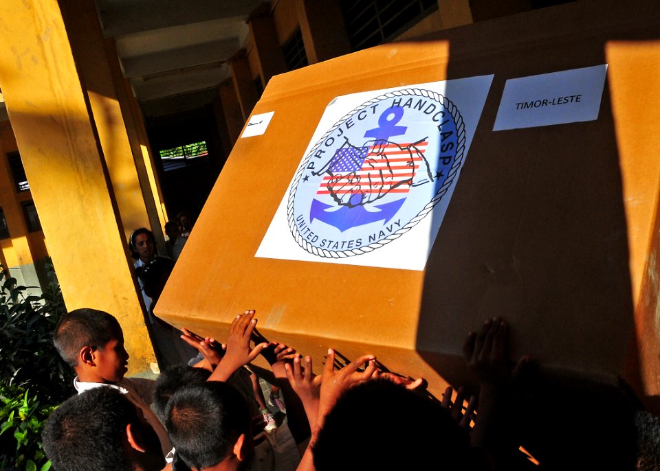 US Navy 110622-O-ZZ999-110 Timorese students from the Alturi Laron Elementary School help deliver a donated Project Handclasp box for the Timor-Les