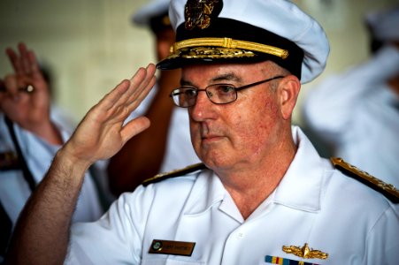 US Navy 110622-N-KK576-015 Adm. John C. Harvey Jr., commander of U.S. Fleet Forces Command, salutes as he is piped aboard during the Navy Cyber For photo