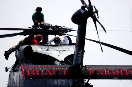 US Navy 110624-N-UO379-161 Sailors assigned to the Black Knights of Helicopter Anti-Submarine Squadron (HS) 4 conduct maintenance on the propeller