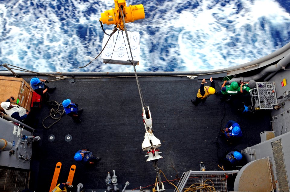 US Navy 110621-N-RC734-132 Sailors assigned to USS Comstock (LSD 45) receive a pallet of supplies during a connected replenishment with USNS Tippec