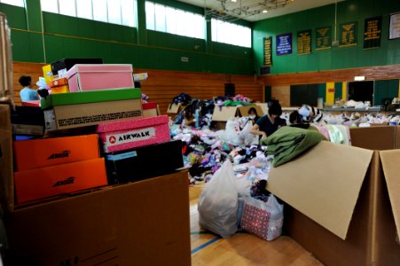 US Navy 110624-N-ZZ999-070 Stacks of shoeboxes await sorting as Misawa Air Base personnel organize materials donated to Japan by listeners of the S