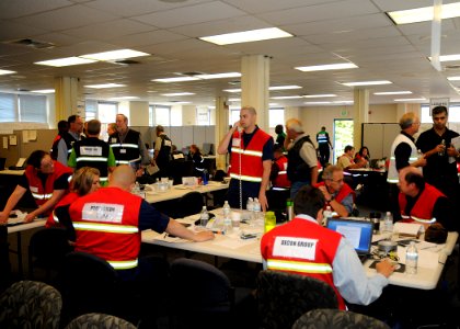 US Navy 110623-N-ZK021-003 Members of the U.S. Coast Guard operations team brief one another on the status of a mock oil spill during the U.S. and