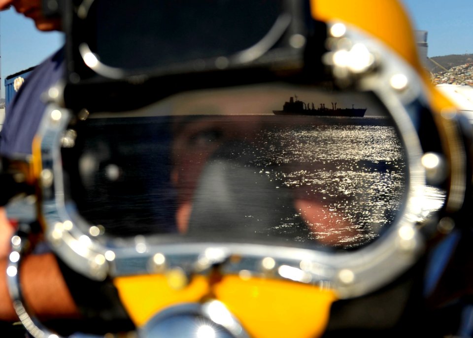 US Navy 110624-N-KB666-197 Navy Diver 2nd Class Ryan Arnold observes the Chilean navy oiler CNS Almirante Montt (AO 52)