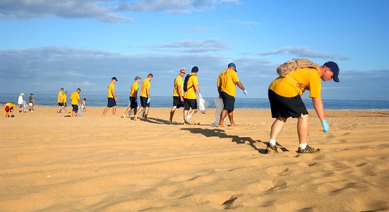 US Navy 110624-N-YU572-007 Sailors and Pacific Missile Range Facility personnel pick up trash during a beach clean up in support of World Oceans Da