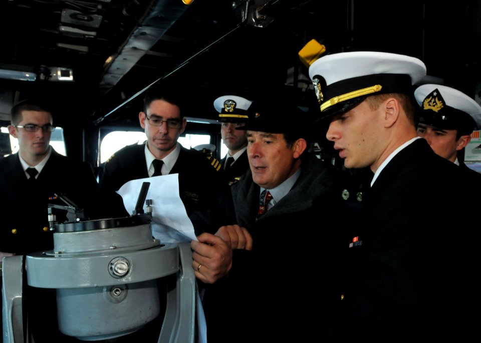 US Navy 110624-N-NL541-069 Cmdr. Jeffrey Scudder, right, commanding officer of the guided-missile frigate USS Thach (FFG 43), looks on as retired C