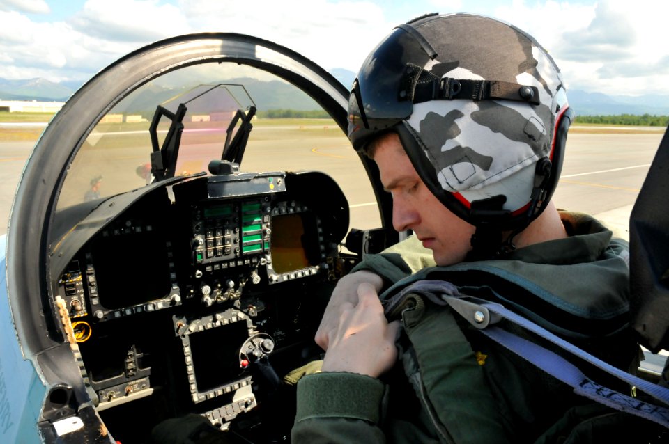 US Navy 110623-N-GO535-024 Lt. Cmdr. Matthew Muggs Maloney secures his safety harness in the cockpit of an F-A-18 Hornet before a mission during No