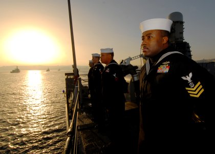 US Navy 110624-N-ZI300-017 Gas Turbine Systems Technician (Mechanical) 1st Class Vincent McKoy mans the rails aboard the guided-missile frigate USS