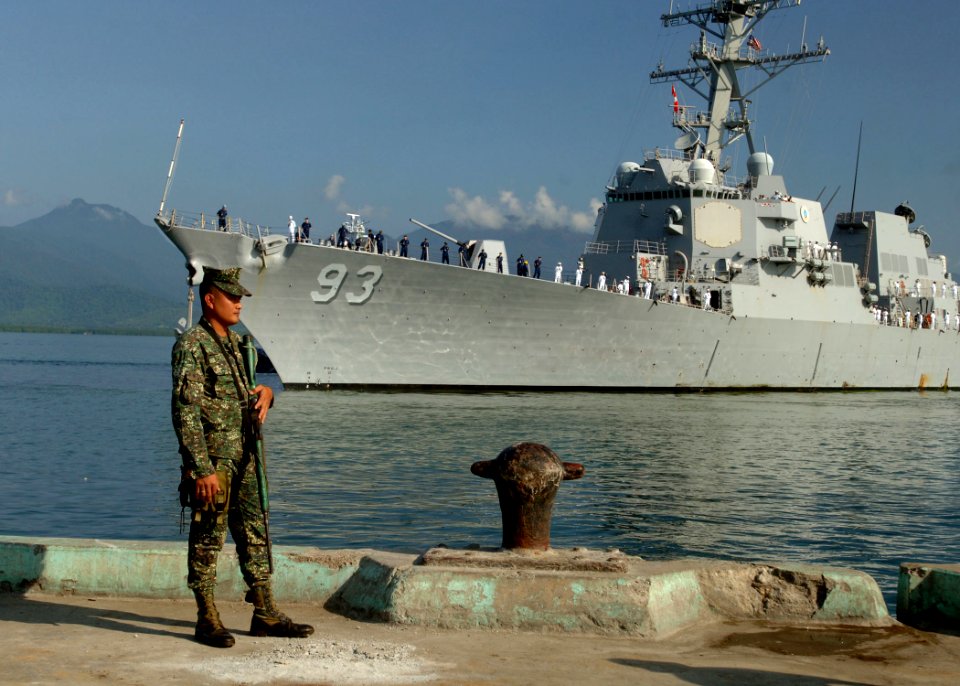 US Navy 110628-N-NJ145-160 An Armed Forces of the Philippines marine sentry stands watch as the guided-missile destroyer USS Chung-Hoon (DDG-93) ar