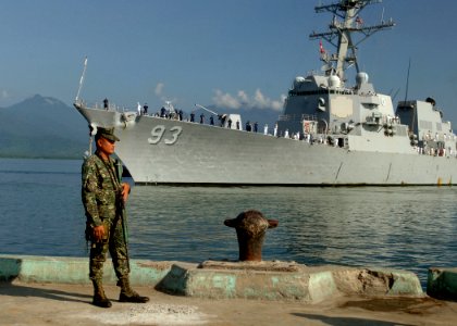 US Navy 110628-N-NJ145-160 An Armed Forces of the Philippines marine sentry stands watch as the guided-missile destroyer USS Chung-Hoon (DDG-93) ar