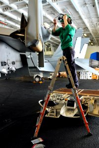 US Navy 110625-N-EE987-045 Aviation Machinist's Mate Airman Journey Domingo, from Manteca, Calif., installs a 159 Canoe panel onto an F-A-18 Super photo