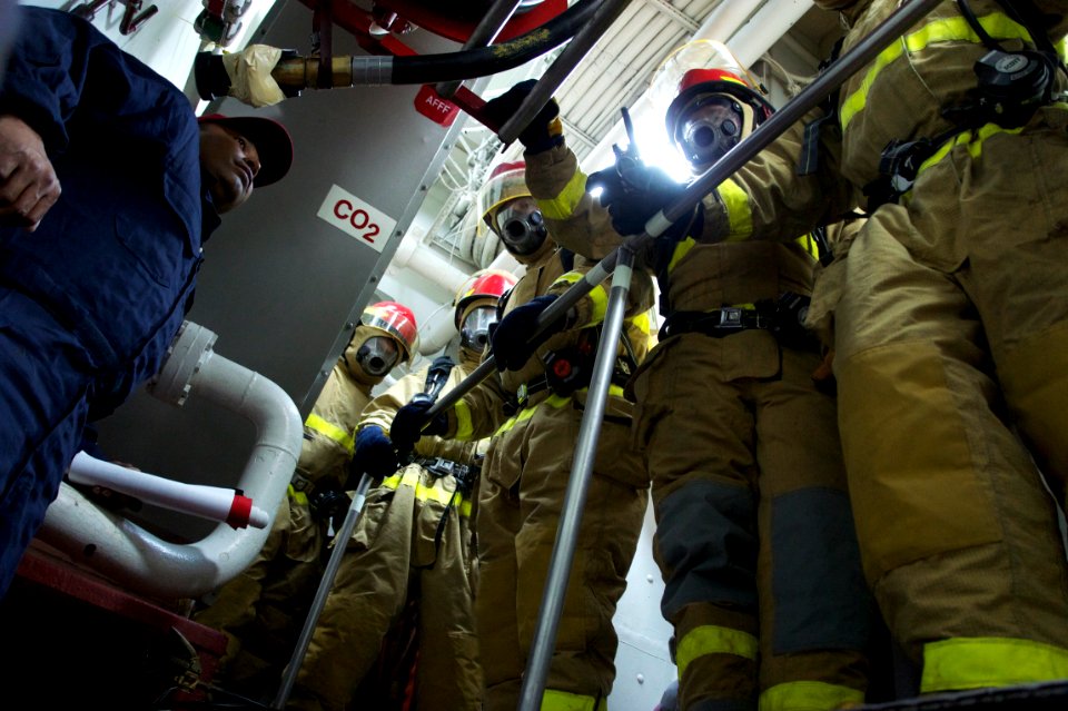 US Navy 110623-N-ZC343-013 Sailors aboard USS Bonhomme Richard (LHD 6) prepare to relieve the primary hose team during a main space fire drill