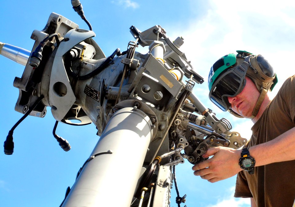 US Navy 110628-O-ZZ999-004 Aviation Structural Mechanic 3rd Class Caleb Daniels works on the tail rotor of an MH-60S Sea Hawk helicopter aboard USS