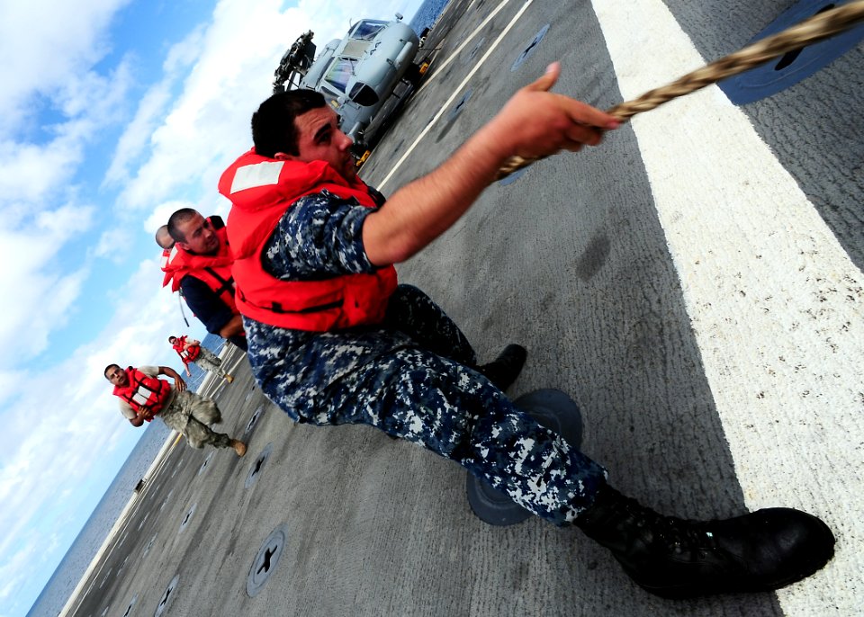 US Navy 110627-F-HS649-479 Sailors perform a line handling evolution during an underway replenishment aboard USS Cleveland (LPD 7)