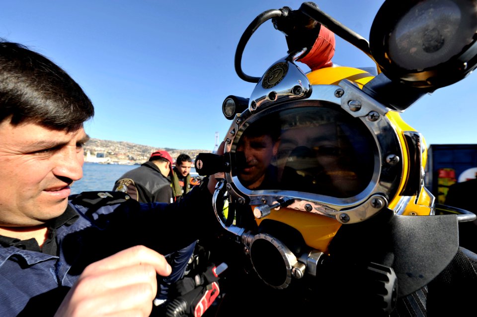 US Navy 110624-N-KB666-110 Second Sgt. Yohan Flores inspects a Chilean diver prior to joint dive operations with (MDSU) 2