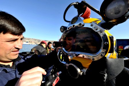 US Navy 110624-N-KB666-110 Second Sgt. Yohan Flores inspects a Chilean diver prior to joint dive operations with (MDSU) 2