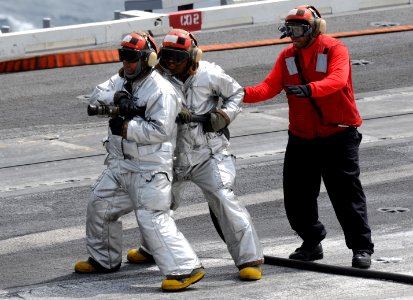 US Navy 110627-N-QL471-029 Sailors man a fire hose during a general quarters training exercise aboard the aircraft carrier USS George H.W. Bush (CV