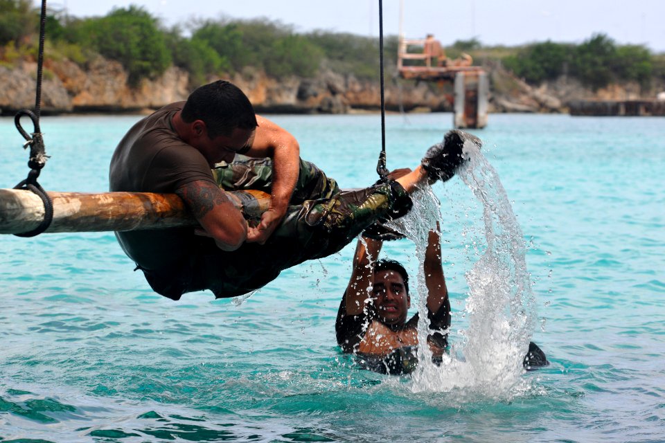 US Navy 110627-N-YO394-207 Aviation Machinist Mate 1st Class Frank Moreno, left, and Gunner's Mate Seaman Jon Castillo, assigned to Riverine Squadr
