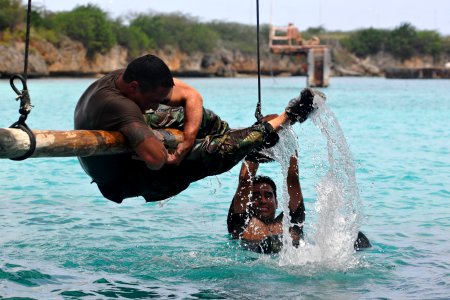 US Navy 110627-N-YO394-207 Aviation Machinist Mate 1st Class Frank Moreno, left, and Gunner's Mate Seaman Jon Castillo, assigned to Riverine Squadr