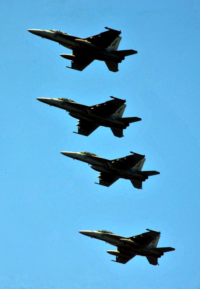 US Navy 110627-N-OP638-007 F-A-18F Super Hornets assigned to the Red Rippers of Strike Fighter Squadron (VFA) 11 fly over the aircraft carrier USS