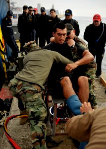 US Navy 110629-N-KB666-125 Divers prepare Navy Diver 3rd Class Bryan Myers for an emergency surface decompression during a demonstration for the Ar