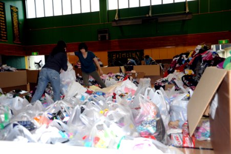 US Navy 110624-N-ZZ999-045 Volunteers from Misawa Air Base sort and bag clothes donated to Japan by listeners of the Seattle area