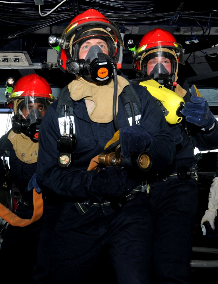 US Navy 110627-N-QL471-178 Sailors man a fire hose during a general quarters training exercise in the pilothouse aboard the aircraft carrier USS Ge