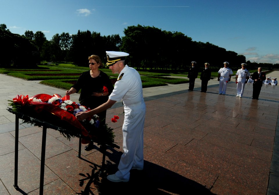 US Navy 110629-N-OM642-508 Cmdr. Patrick E. Kulakowski lays a wreath with Consulate General of the United States Sheila Gwaltney during a wreath ce