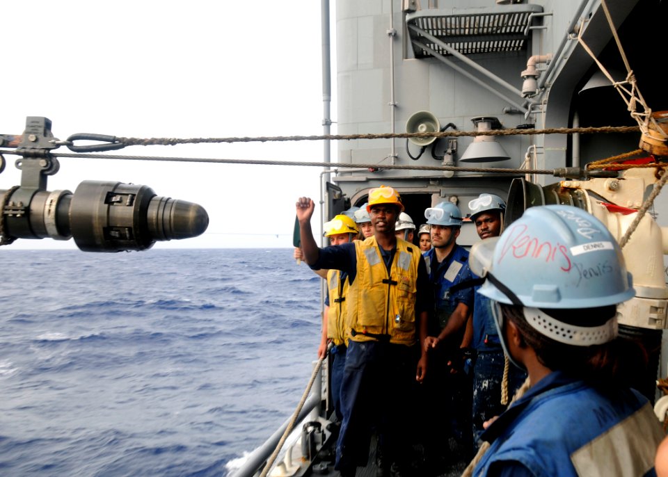US Navy 110627-N-KB052-408 Seaman Jordan Jones gives the avast signal to line handlers aboard the Ticonderoga-class guided-missile cruiser USS Cow