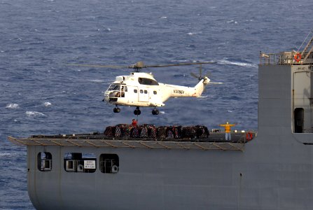 US Navy 110625-N-QL471-313 A civilian mariner aboard the Military Sealift Command dry cargo and ammunition ship USNS Alan Shepard (T-AKE 3) attache