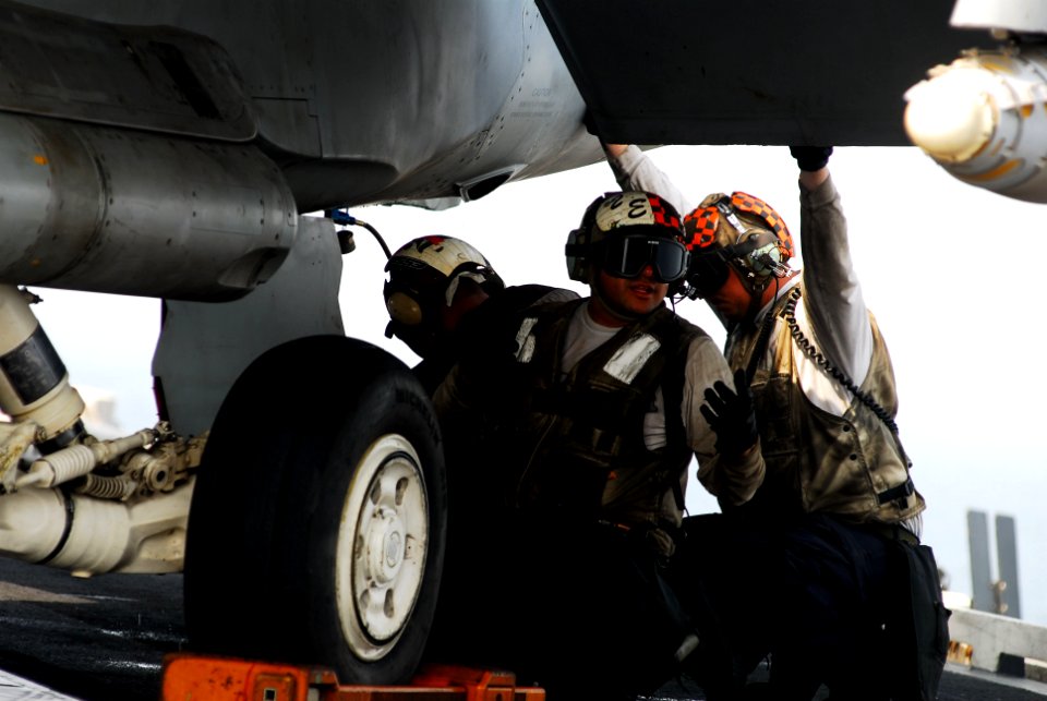 US Navy 110630-N-GL340-035 Sailors perform routine maintenance on an aircraft before flight operations aboard the aircraft carrier USS Ronald Reaga