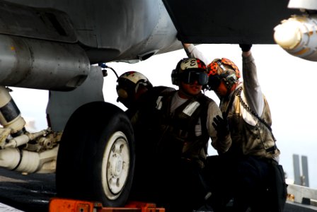 US Navy 110630-N-GL340-035 Sailors perform routine maintenance on an aircraft before flight operations aboard the aircraft carrier USS Ronald Reaga