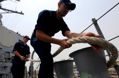 US Navy 110626-N-TB177-258 Cryptologic Technician (Collection) Seaman Recruit Alex Wright wraps a line around a bit aboard the guided-missile destr