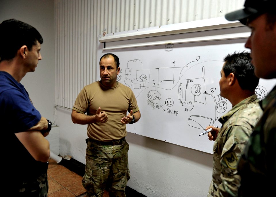 US Navy 110628-N-KB666-082 Lt. Javier Amor, assigned to the Armada de Chile, explains the conditions behind a recent dive casualty to Lt. Benjay K