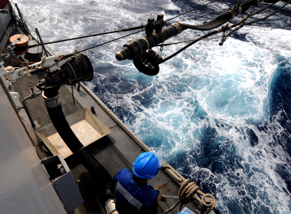 US Navy 110628-N-TB177-222 A Sailor stands by as a fuel probe approaches a connector during a refueling at sea aboard the guided-missile destroyer