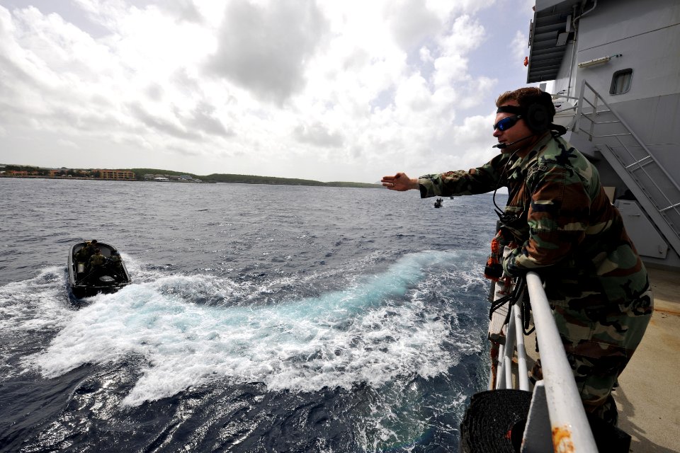 US Navy 110628-N-YO394-077 A Royal Netherlands Marine directs Sailors assigned to Riverine Squadron (RIVRON) 3 during maneuvers near the Royal Neth