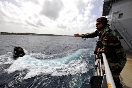 US Navy 110628-N-YO394-077 A Royal Netherlands Marine directs Sailors assigned to Riverine Squadron (RIVRON) 3 during maneuvers near the Royal Neth